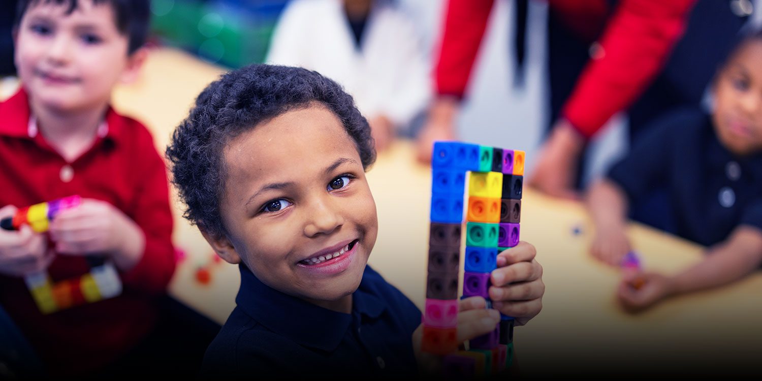 Smiling student in a classroom.